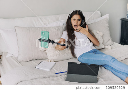Beautiful pre-teen girl using modern wireless tech Beautiful pre-teen girl using modern wireless tech 109520629