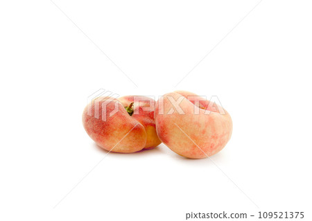 Two saturn peaches or flat peaches isolated on white background with clipping path.. 109521375