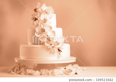 AI-generated content. A beautiful peach-colored birthday cake on a background with a place to copy.  109521682