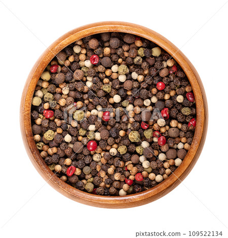 Piquant peppercorn mix in a wooden bowl. Spicy mixture of dried and whole black, green and white and peppercorns, rose pepper, coriander and allspice, to use in the pepper mill. Isolated, food photo. Piquant peppercorn mix in a wooden bowl. Spicy mixture of dried and whole black, green and white and peppercorns, rose pepper, coriander and allspice, to use in the pepper mill. Isolated, food photo. 109522134