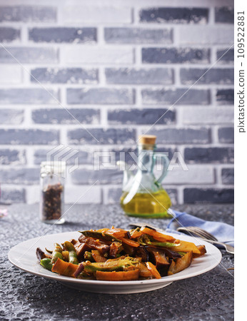 Chopped cooked vegetables on dark background, Traditional ratatouille with zucchini, bell pepper and eggplant 109522881
