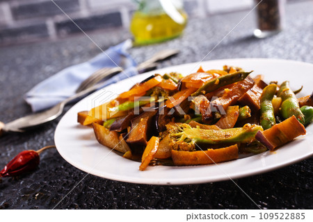 Chopped cooked vegetables on dark background, Traditional ratatouille with zucchini, bell pepper and eggplant Chopped cooked vegetables on dark background, Traditional ratatouille with zucchini, bell pepper and eggplant 109522885