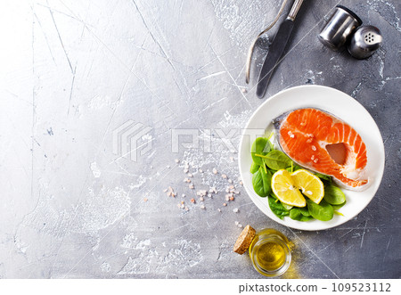 raw salmon steaks and different spices, diet food raw salmon steaks and different spices, diet food 109523112