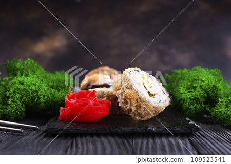 Sushi roll with salmon, smoked eel, avocado, cream cheese on black background. Sushi menu. Japanese food. 109523541