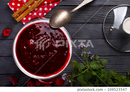 Raspberry jam with berry on dark background. 109523547