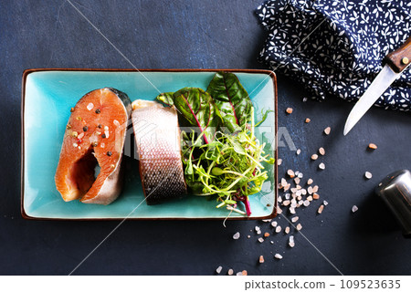 raw salmon steaks and different spices, diet food raw salmon steaks and different spices, diet food 109523635