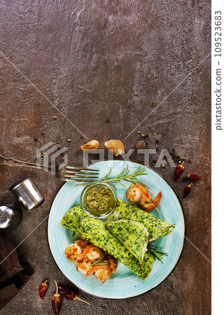 Rolls of spinach pancakes with cheese and shrimps 109523683