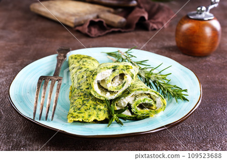 Rolls of spinach pancakes with cheese and shrimps Rolls of spinach pancakes with cheese and shrimps 109523688