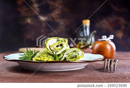 Rolls of spinach pancakes with cheese and shrimps Rolls of spinach pancakes with cheese and shrimps 109523690