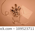 Cosmetics and cosmetic brushes are laid out on the table.  109523711