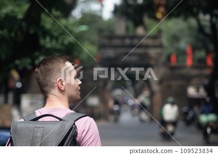 Traveler walking on busy street in Hanoi. Traveler walking on busy street in Hanoi. 109523834
