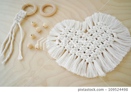 Macrame handmade napkin in the form of heart. Eco diy home decoration. Natural materials, cotton thread. St. Valentine's Day. Macrame handmade napkin in the form of heart. Eco diy home decoration. Natural materials, cotton thread. St. Valentine's Day. 109524498