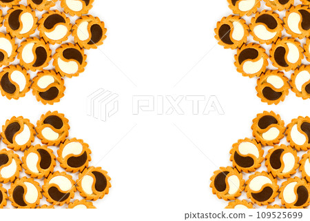 Cookies with dark and white chocolate isolated on a white. Beautiful pattern. Free space for text. Cookies with dark and white chocolate isolated on a white. Beautiful pattern. Free space for text. 109525699