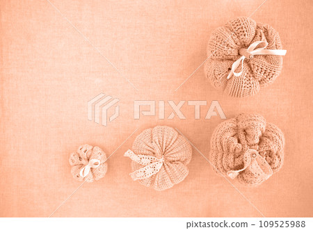 Hobby background with handmade knit pumpkins. DIY, craft decoration for fall and winter holidays. Flat lay, top view Peach fuzz is color of year 2024 tinted image Hobby background with handmade knit pumpkins. DIY, craft decoration for fall and winter holidays. Flat lay, top view Peach fuzz is color of year 2024 tinted image 109525988