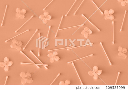 White buds near white jasmine flowers on light pink, close up. Skincare product for everyday beauty routine. Peach fuzz is color of year 2024 tinted image 109525999