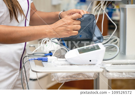 Female nurse checking blood pressure of a senior woman Female nurse checking blood pressure of a senior woman 109526572