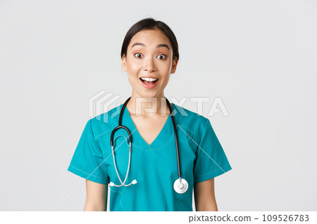 Healthcare workers, preventing virus, quarantine campaign concept. Happy and excited asian female doctor, physician in scrubs look amazed, hear awesome news, white background Healthcare workers, preventing virus, quarantine campaign concept. Happy and excited asian female doctor, physician in scrubs look amazed, hear awesome news, white background 109526783