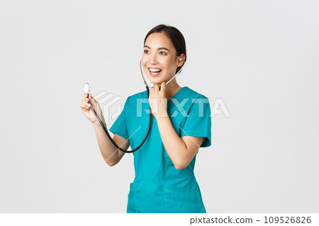 Covid-19, healthcare workers and preventing virus concept. Smiling friendly-looking asian female doctor listening to patient lungs during daily checkup, using stethoscope, white background Covid-19, healthcare workers and preventing virus concept. Smiling friendly-looking asian female doctor listening to patient lungs during daily checkup, using stethoscope, white background 109526826