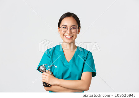 Covid-19, coronavirus disease, healthcare workers concept. Confident happy asian female physician, doctor in glasses, cross arms chest and smiling, holding stethoscope for examination Covid-19, coronavirus disease, healthcare workers concept. Confident happy asian female physician, doctor in glasses, cross arms chest and smiling, holding stethoscope for examination 109526945