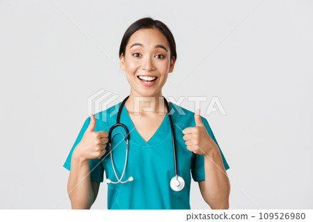 Healthcare workers, preventing virus, quarantine campaign concept. Young supportive asian nurse give thumbs-up. Doctor cheer-up patient, encourage someone or compliment, white background 109526980