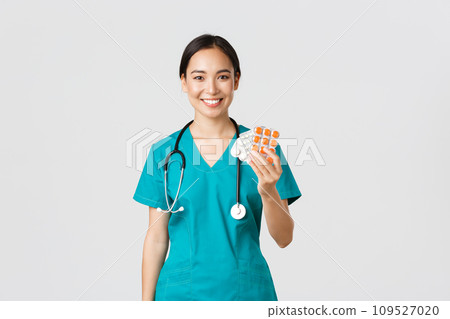 Healthcare workers, preventing virus, quarantine campaign concept. Friendly-looking female asian nurse, doctor explain patient medication prescription, showing drugs and smiling, white background 109527020