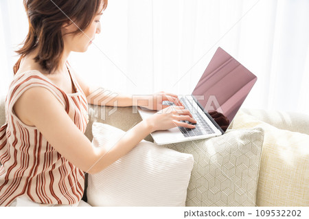 Woman hand watching personal computer in room Woman hand watching personal computer in room 109532202