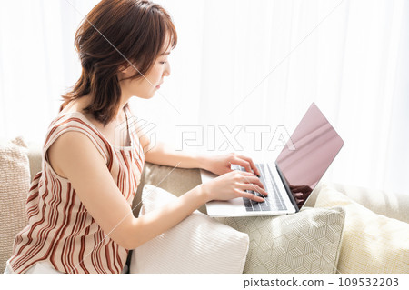 Woman hand watching personal computer in room 109532203