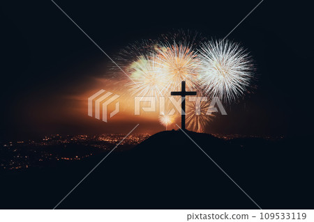 Christmas fireworks festival and fireworks to celebrate the holiday season and New Year, New Year's night cityscape and church cross silhouette Christmas fireworks festival and fireworks to celebrate the holiday season and New Year, New Year's night cityscape and church cross silhouette 109533119