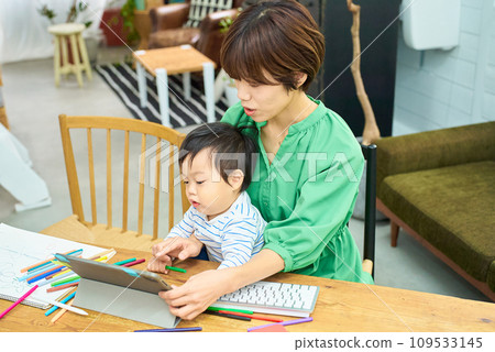 A woman working from home with a baby 109533145