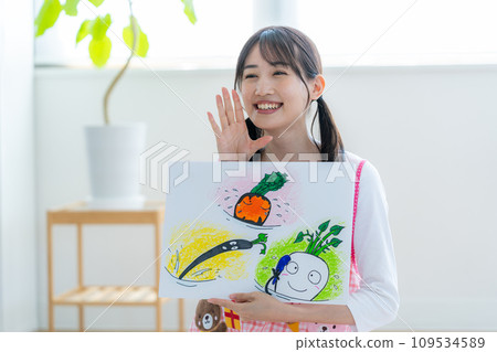 A nursery teacher who plays a picture-story show A nursery teacher who plays a picture-story show 109534589