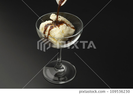Affogato espresso pouring glass black background 109536230