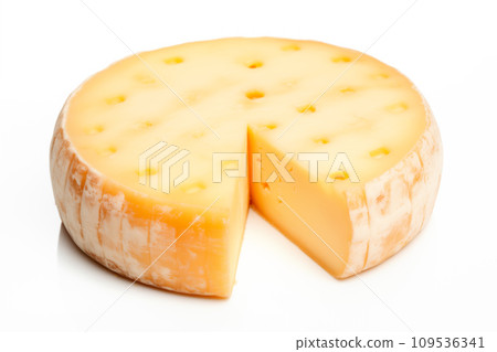 A closeup of a cheese with a slice taken away with holes like maasdam, emmental or cheddar as background 109536341