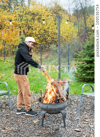A man lights a barbecue in nature 109536754