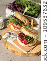Lean burgers with a corn flour bun, micro greenery and slices of fresh berries. Close-up, natural light 109537632
