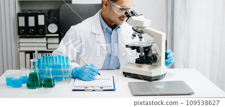 Scientist mixing chemical liquids in the chemistry lab. Researcher working in chemical laboratory. Scientist mixing chemical liquids in the chemistry lab. Researcher working in chemical laboratory. 109538627