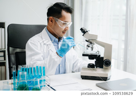 Modern medical research laboratory. male scientist working with micro pipettes analyzing biochemical samples, advanced science chemical laboratory medicine. Modern medical research laboratory. male scientist working with micro pipettes analyzing biochemical samples, advanced science chemical laboratory medicine. 109538629