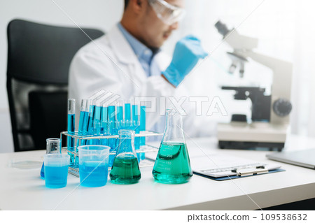 Scientist mixing chemical liquids in the chemistry lab. Researcher working in chemical laboratory. Scientist mixing chemical liquids in the chemistry lab. Researcher working in chemical laboratory. 109538632
