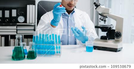 Scientist mixing chemical liquids in the chemistry lab. Researcher working in chemical laboratory. Scientist mixing chemical liquids in the chemistry lab. Researcher working in chemical laboratory. 109538679