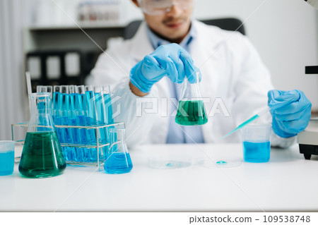 Mmale biotechnologist testing new chemical substances in a laboratory... 109538748