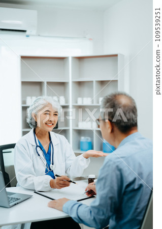 Asian Senior Doctor and patient discussing something while sitting at the table . Medicine and health care concept. 109539251