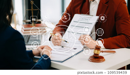 justice and law concept. asian woman lawyer working and judge in a courtroom the gavel, working with tablet and laptop and digital tablet computer on white table with VR icon. 109539439