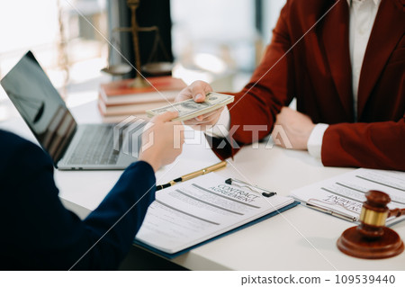 justice and law concept.passing bribe money in the envelop at lawyer office. businessman hand taking bribe money from female 109539440