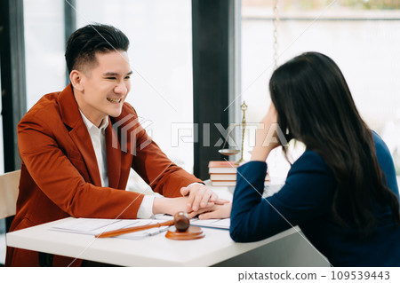 Business people compassionately holding hands and discussing contract papers with laptop and tabletat office room.. Business people compassionately holding hands and discussing contract papers with laptop and tabletat office room.. 109539443