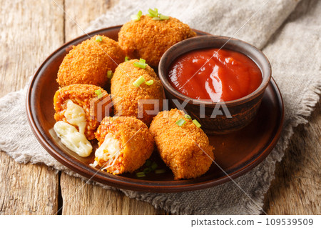 Italian Rice balls stuffed with mozzarella cheese and deep fried closeup on the plate. Horizontal Italian Rice balls stuffed with mozzarella cheese and deep fried closeup on the plate. Horizontal 109539509
