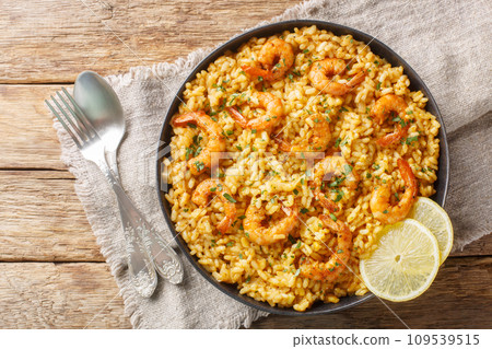Shrimp risotto pairing the bold flavors of Parmesan and lemon with creamy rice and juicy shrimp closeup on the plate. Horizontal top view Shrimp risotto pairing the bold flavors of Parmesan and lemon with creamy rice and juicy shrimp closeup on the plate. Horizontal top view 109539515