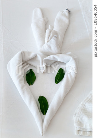 Bed decoration in a Turkish hotel from folded towels Bed decoration in a Turkish hotel from folded towels 109540054