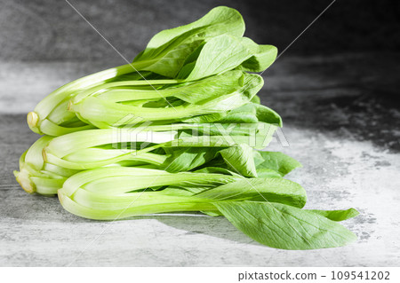 Vegetable greens on black background plate 109541202