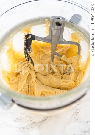 Mixing ingredients in kitchen electric mixer to bake American flag mini cupcakes. Mixing ingredients in kitchen electric mixer to bake American flag mini cupcakes. 109542328