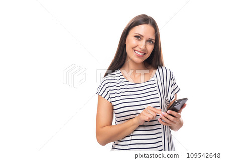 portrait of a young cute casual european woman with long dark hair dressed in a striped t-shirt 109542648
