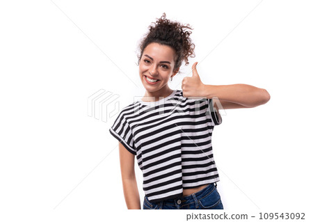 young joyful caucasian woman with curly black hair is dressed in a striped black and white t-shirt 109543092